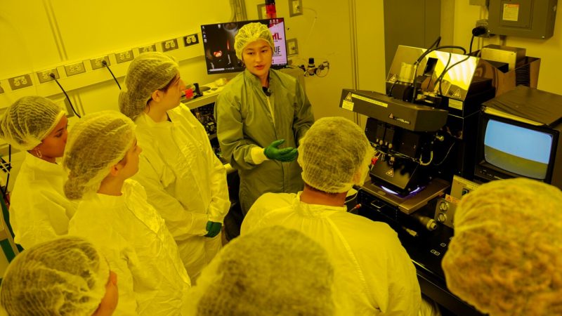 Participants in the UPWARDS summer camp fabricate semiconductors in Virginia Tech's clean lab. The clean lab uses special amber tinted lighting to protect the delicate electronics used in semiconductors. (Photo by Luke Hayes/Virginia Tech)